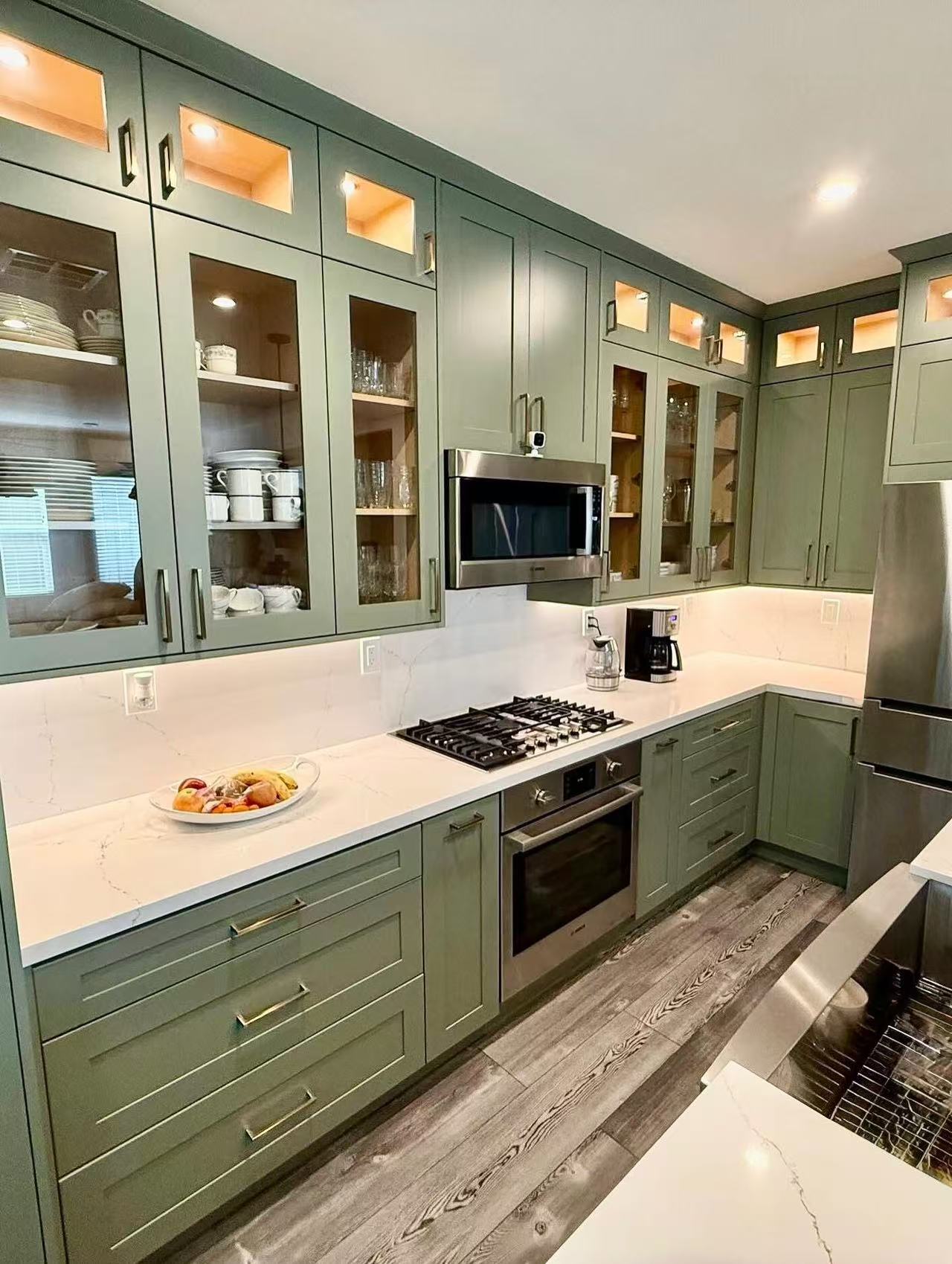 Sage green shaker style cabinets